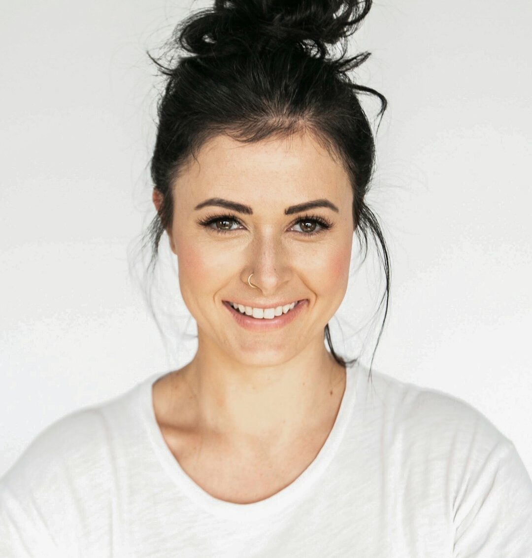 woman in white crew neck shirt smiling